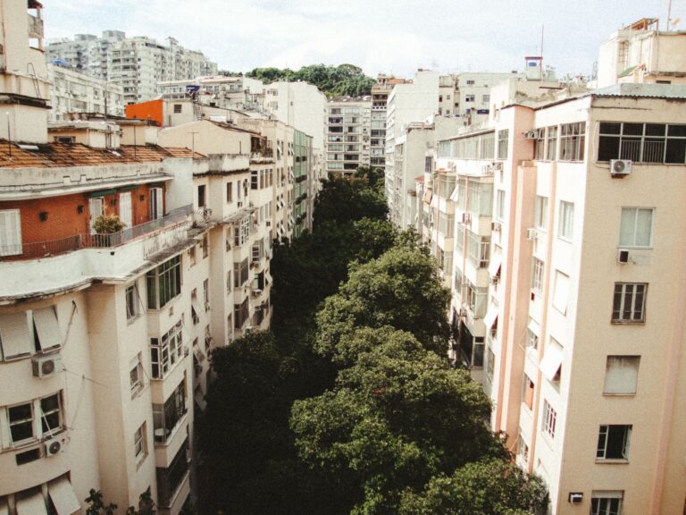 Aerial view showcasing Rio de Janeiro's urban apartment buildings and lush greenery between them.