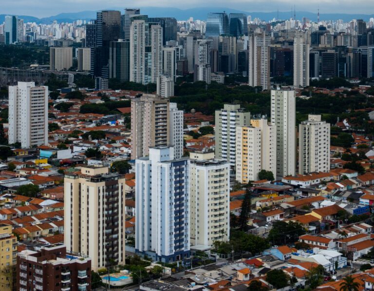 High-angle view of an urban cityscape featuring dense skyscrapers and residential buildings.