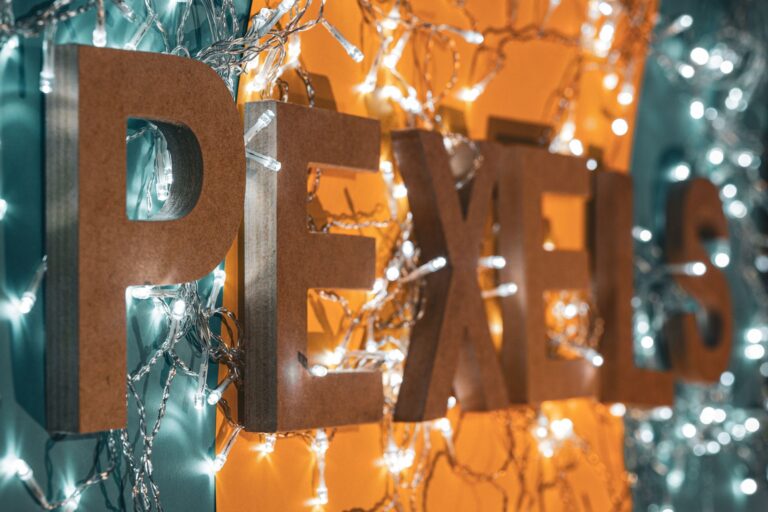 Close-up of wooden 'Pexels' letters decorated with string lights in Ciudad de México.