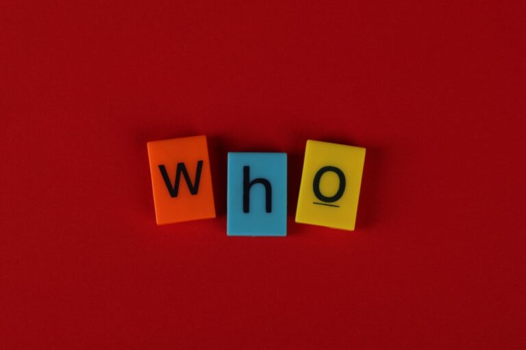 Alphabet blocks forming the word 'who' against a vibrant red backdrop.