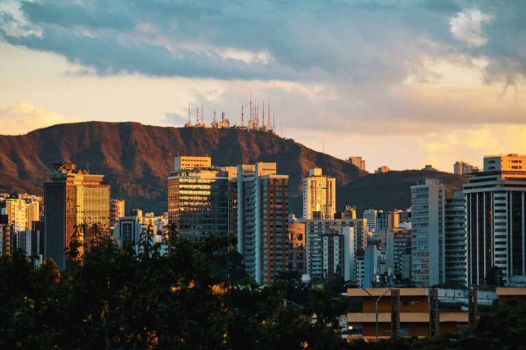 Stunning view of Belo Horizonte cityscape framed by Serra do Curral during a golden sunset.