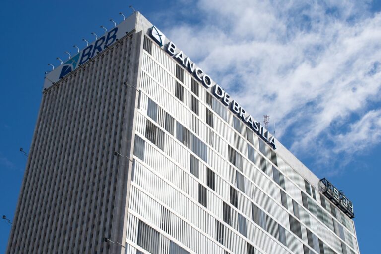 High-rise view of Banco de Brasília against a bright blue sky in Distrito Federal, Brazil.